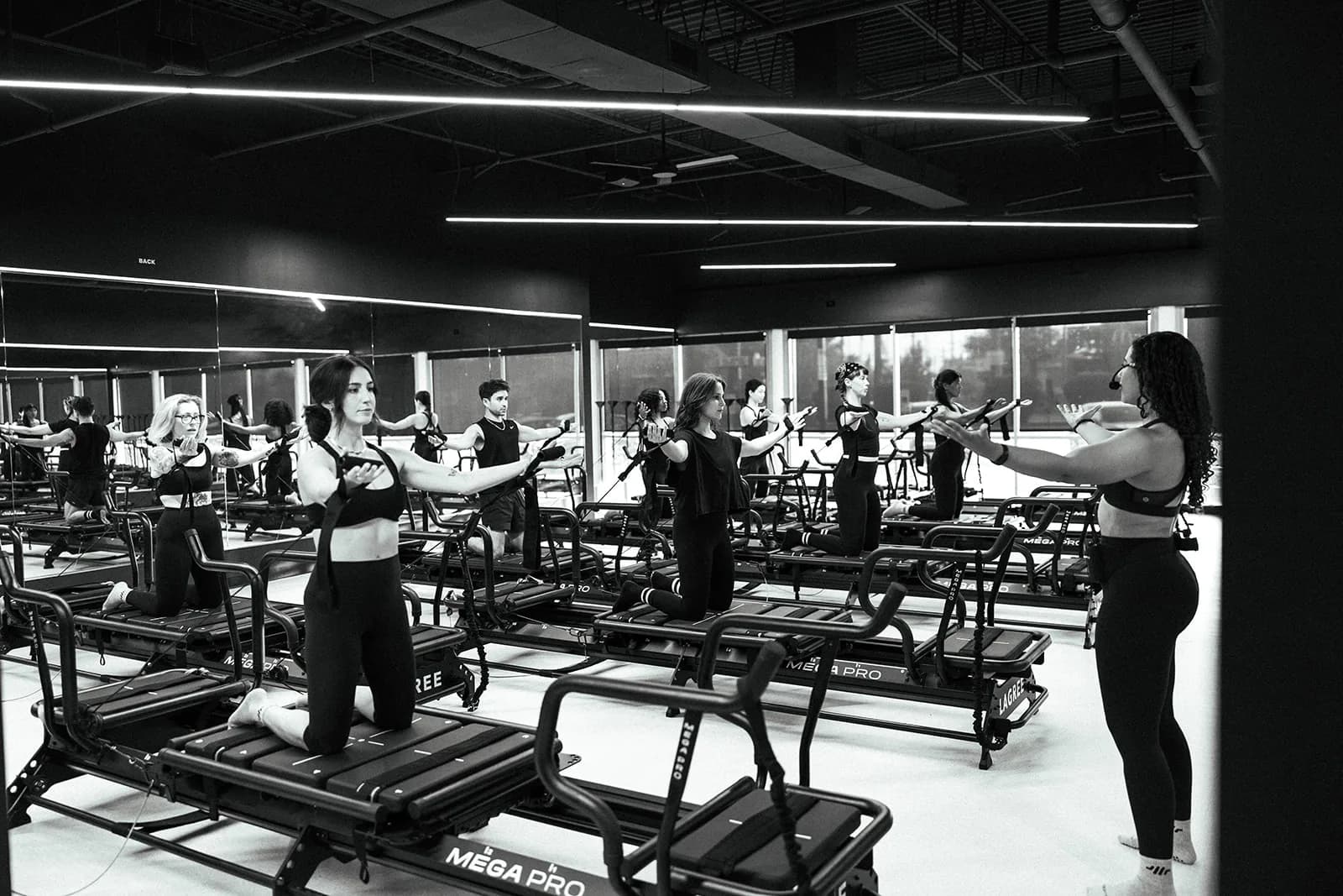 Clients working out together on Megaformers during a Resistance class