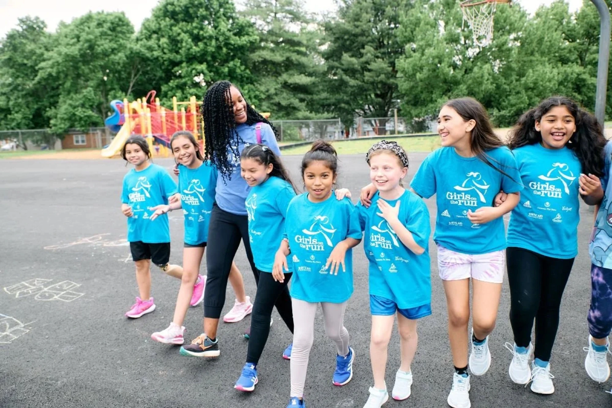 A Girls on the Run participant with a trainer
